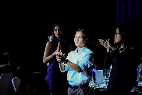 Anne Goh (centre), representative of Sayoni, clapping at AWARE’s 12th Anniversary Ball on 7 September 2024. Photograph by Khoo Yi Ting (@ytshoots).